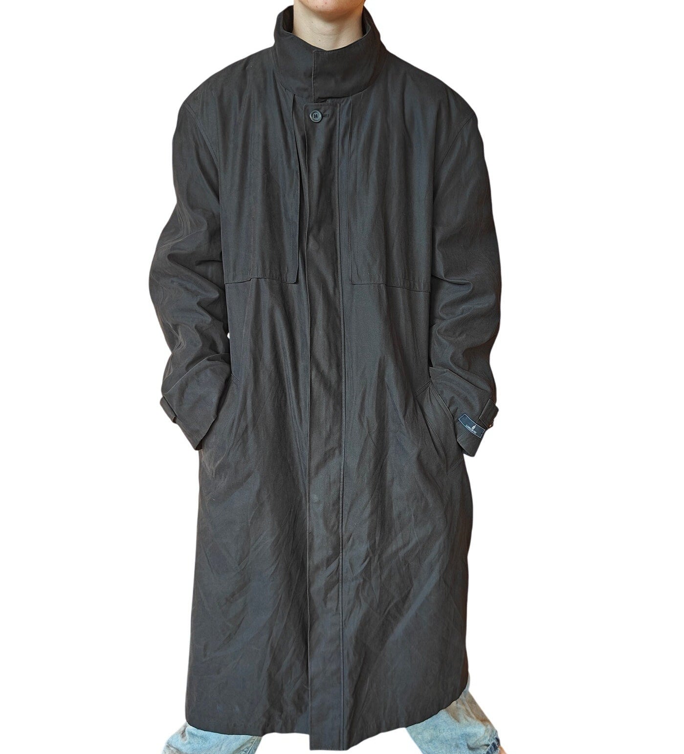 Long dark coat worn by a person on a white background